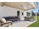 Covered patio offering a dark grey sectional and table with chairs for relaxing and entertaining at 5270 Birch Valley Rd, Cumming, GA 30028