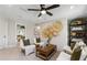 Bright sitting area with comfortable seating, decorative wall art, and stylish shelving unit at 5270 Birch Valley Rd, Cumming, GA 30028