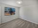 Bright bedroom with large window, wood-look floors, and neutral walls at 9129 Bent Pine Ne Ct, Covington, GA 30014
