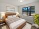 Modern staged bedroom with large window and view of the neighborhood at 9129 Bent Pine Ne Ct, Covington, GA 30014