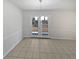Dining room with tiled floors and double doors leading to backyard at 9129 Bent Pine Ne Ct, Covington, GA 30014