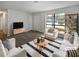 Virtually staged living room with modern furniture and large windows at 9129 Bent Pine Ne Ct, Covington, GA 30014