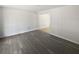 Open living room with wood-look floors and view into dining area at 9129 Bent Pine Ne Ct, Covington, GA 30014