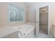 Relaxing bathroom with a large bathtub and marble flooring at 188 Cannon Trl, Dallas, GA 30157