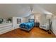 Small bedroom with hardwood floors, gray chair, and wood dresser at 1949 Westminster Ne Way, Atlanta, GA 30307