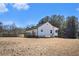 White house with green roof and large backyard at 60 Collins Road, Carrollton, GA 30116