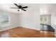 Living room with hardwood floors, ceiling fan, and access to deck at 60 Collins Road, Carrollton, GA 30116