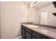 A functional bathroom featuring a dark vanity, granite countertop, and a large mirror at 162 Townview Dr, Woodstock, GA 30189