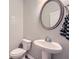 Elegant powder room with pedestal sink and decorative mirror at 162 Townview Dr, Woodstock, GA 30189