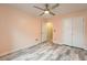 A stylish bedroom featuring a ceiling fan, wood-look floors, and a closet at 162 Townview Dr, Woodstock, GA 30189