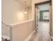 A hallway leading to a bedroom, with wood-look flooring and natural light at 162 Townview Dr, Woodstock, GA 30189