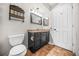 Functional bathroom with a toilet, sink, mirror, and decorative accents at 23 Chelsea Ct, Avondale Estates, GA 30002