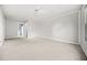 Neutral-carpeted bedroom with light gray walls and a view to an ensuite bathroom at 23 Chelsea Ct, Avondale Estates, GA 30002