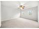 The empty bedroom has carpet, a ceiling fan, and bright natural light from the windows at 23 Chelsea Ct, Avondale Estates, GA 30002
