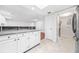 Modern kitchen with granite countertops, white cabinets and stainless-steel appliances near washer and dryer at 23 Chelsea Ct, Avondale Estates, GA 30002