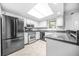 Modern kitchen with stainless steel appliances and granite countertops under bright lights at 23 Chelsea Ct, Avondale Estates, GA 30002