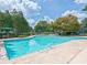 Community pool surrounded by lush greenery, offering a refreshing and relaxing amenity at 23 Chelsea Ct, Avondale Estates, GA 30002