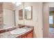 Vanity with decorative lighting above a large mirror in the bathroom at 1250 Parkwood Se Cir # 1004, Atlanta, GA 30339