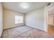 Bedroom featuring neutral carpet, natural light from window, and ensuite bathroom at 1250 Parkwood Se Cir # 1004, Atlanta, GA 30339