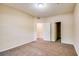 A carpeted bedroom has two doors and neutral walls, with an open closet at 1250 Parkwood Se Cir # 1004, Atlanta, GA 30339