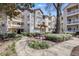 A sidewalk leads to the building exterior with balconies at Parkwood Place Condominiums at 1250 Parkwood Se Cir # 1004, Atlanta, GA 30339