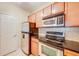 Well-equipped kitchen featuring stainless steel appliances and wood cabinetry at 1250 Parkwood Se Cir # 1004, Atlanta, GA 30339