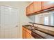 Kitchenette featuring a sink, wooden cabinets, and a view of the living area at 1250 Parkwood Se Cir # 1004, Atlanta, GA 30339