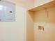 This laundry room has a utility sink hook-up and a shelf for storage, as well as an electrical panel at 1250 Parkwood Se Cir # 1004, Atlanta, GA 30339
