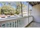 A sheltered patio offers views of a parking area and lush greenery beyond white railings at 1250 Parkwood Se Cir # 1004, Atlanta, GA 30339