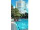 Relaxing community pool area with lounge chairs and lush landscaping in front of large building at 1250 Parkwood Se Cir # 1004, Atlanta, GA 30339