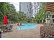Beautiful community pool with lounge chairs and lush landscaping at 1250 Parkwood Se Cir # 1004, Atlanta, GA 30339