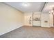 Bright living room boasts neutral paint, comfortable carpeting, and a view of the adjacent kitchen area at 1250 Parkwood Se Cir # 1004, Atlanta, GA 30339