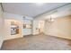 Spacious living room featuring neutral carpeting, open access to the kitchen, and modern chandelier lighting at 1250 Parkwood Se Cir # 1004, Atlanta, GA 30339