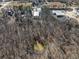 Aerial view of wooded lot with pond and nearby buildings at 200 Heath Rd, Carrollton, GA 30116