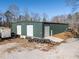 Large green metal building with three garage doors at 200 Heath Rd, Carrollton, GA 30116
