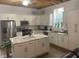 Modern kitchen with white cabinets, marble countertops, and stainless steel appliances at 200 Heath Rd, Carrollton, GA 30116