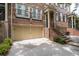 Brick townhome with a two-car garage and staircase leading to the entrance at 2858 Overlook Trce, Atlanta, GA 30324