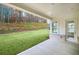 Covered back porch overlooking a lush green yard, perfect for outdoor relaxation and entertaining at 6540 Namon Creek Trl, Cumming, GA 30028