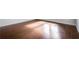Close-up showcasing the pristine hardwood flooring with light reflecting on the smooth surface at 6540 Namon Creek Trl, Cumming, GA 30028