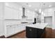 Modern kitchen with an island, white cabinets, stainless steel appliances, and hardwood floors at 6540 Namon Creek Trl, Cumming, GA 30028