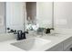 Elegant bathroom featuring double sinks, white countertops and black fixtures at 714 Smokey Quartz Way, Kennesaw, GA 30144