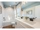 Bright bathroom with double sink vanity, framed art, and a bathtub shower at 714 Smokey Quartz Way, Kennesaw, GA 30144