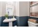 Stylish powder room with blue wainscoting and white pedestal sink at 714 Smokey Quartz Way, Kennesaw, GA 30144