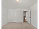 Spacious bedroom with carpeting, access to hallway, and two doors at 714 Smokey Quartz Way, Kennesaw, GA 30144
