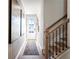 Bright entryway featuring hardwood floors, modern wall decor, and a glass-paned door to the outdoors at 714 Smokey Quartz Way, Kennesaw, GA 30144