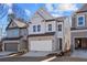 Two-story home with gray siding, stone accents, and a two-car garage at 714 Smokey Quartz Way, Kennesaw, GA 30144