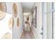 Inviting hallway featuring decorative wall art, a patterned rug, and an open view into the living area at 714 Smokey Quartz Way, Kennesaw, GA 30144