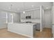 Modern kitchen with gray cabinets, quartz countertops and island at 714 Smokey Quartz Way, Kennesaw, GA 30144