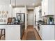 Modern kitchen with white cabinets, stainless appliances, and a stylish island with barstool seating at 714 Smokey Quartz Way, Kennesaw, GA 30144