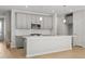 Modern kitchen with gray cabinets, quartz countertops, and island at 714 Smokey Quartz Way, Kennesaw, GA 30144